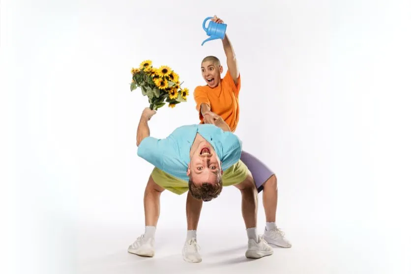 couple in a cheerful dance pose.